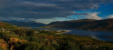 an evening view from an overlook, above the village of ullapool and loch broom, on the northwest coast of scotland.の写真素材
