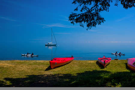 two groups of kayakers, enjoying a rare placid lake superior, in northeastern minnesota.の写真素材