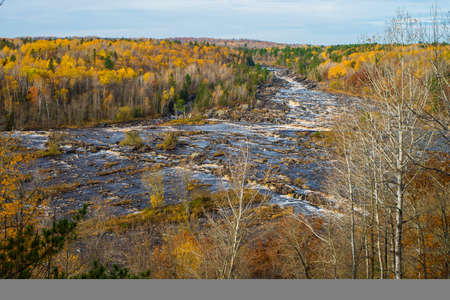 the saint louis river tumbles downward through a boreal forest in autumn, in jay cooke state park., minnesota.の写真素材
