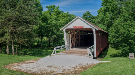built in 1870, the historic cuttler-donahoe covered bridge, crosses over a small creek, in middle river park, winterset, iowa.の写真素材