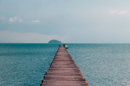 Fisherman throws net from Ocean Pier on tropical islandの写真素材