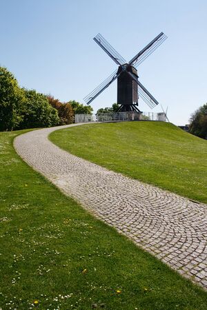 Windmill and path with a clear blue sky in Bruges, Belgium, Europeの写真素材