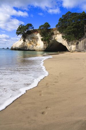 Cathedral Cove Coromandel Arch Footprints on beach in New Zealandの写真素材