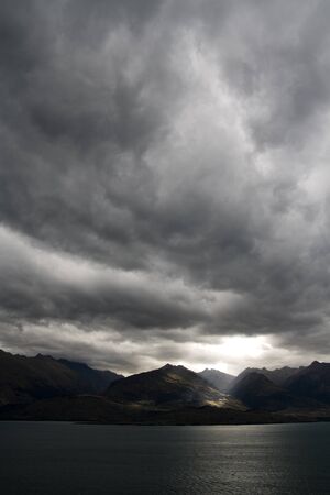 Dark moody sky over mountain rangeの写真素材