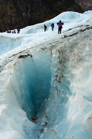Glacier Hike across ice crevasse in Franz Joseph, New Zealandの写真素材