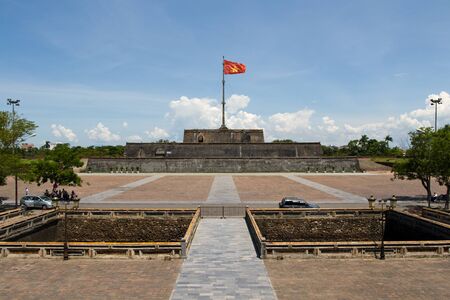 Vietnam flag standing on flag pole above historic Hue Citadel wallのeditorial素材