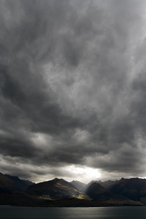 Dark moody sky over mountain range, new zealandの写真素材