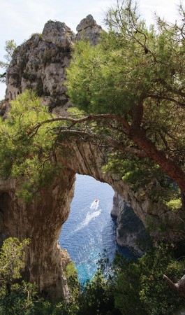 Capri island rock arch and boat - Italy