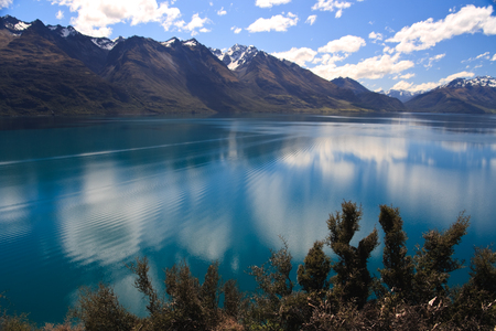 Scenic view of Lake Wakatipu with Southern Alps in background near Queenstown, South Island, New Zealandの写真素材