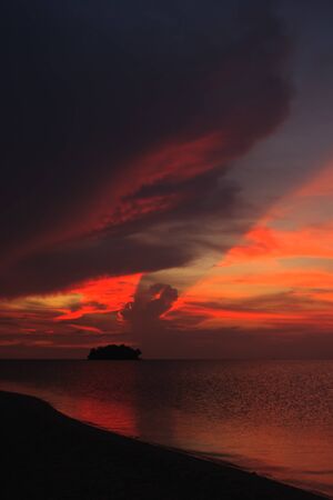 Sunset over island silouetteの写真素材