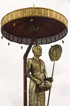 Old golden Buddist statue of monkの写真素材