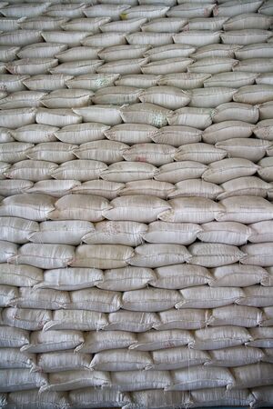 Wall of stacked rice sacks in grain factory, Vietnamの写真素材