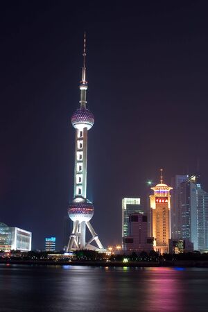 large tower lit up by the city lightsの写真素材