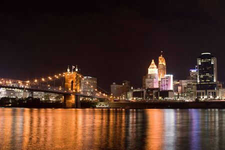 bridge leading into a city at nightの写真素材
