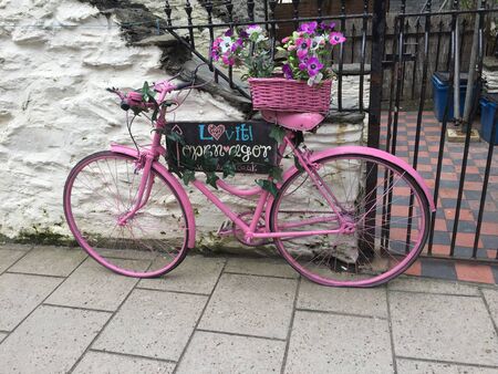 Pretty pink bicycle on pavement, Walesの写真素材