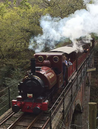 Steam train crossing brick bridge Walesの写真素材