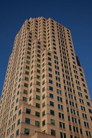 Tall urban office building with a very blue sky.の写真素材