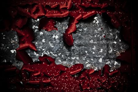 A gunge look at some galvinized metal with rich red paint peeling, providing a myriad of textures and light.の写真素材