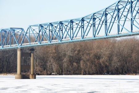 Blue Bridge over Snowy Riverの写真素材