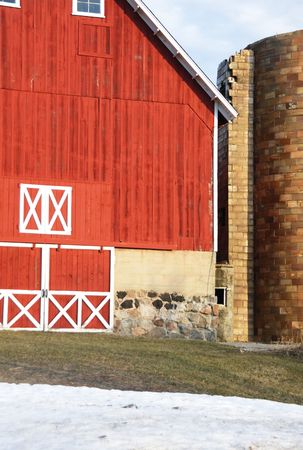 Red Barn with Stone Silo in Winterの写真素材