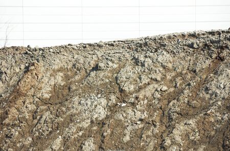 White Wall Behind Pile of Dirt