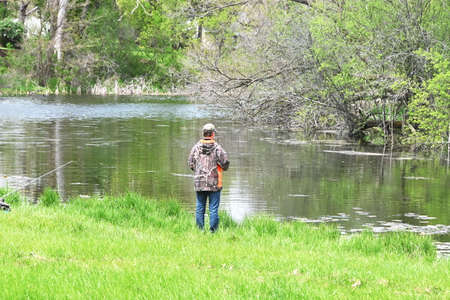 Man Fishing by Riverの写真素材