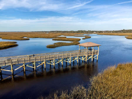 Aerial view of a wooden pier in a marshy area with reeds.の写真素材
