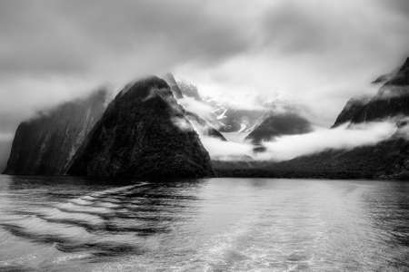 Dramatic moody Milford Sound still beautiful in the pouring rain low cloud and mistの写真素材
