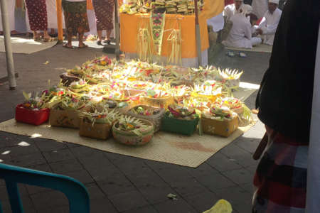 table full of religious offerings inside the temple during the Hindu ceremony in Bali Indonesiaの写真素材