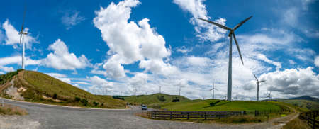 Massive wind turbine towers generating electricity in beautiful rural agricultural  countrysideの写真素材