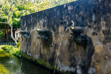 Landscaped water feature in the manicured gardens of the tourist resortの写真素材