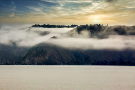 Magical  mystical trip sailing through Cooks Strait in low cloud mist fog and heavy rainの写真素材