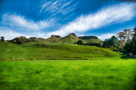 Lush green grazing farmland in the valley and hills of Tuki Tuki below the dramatic Te Mata peak ridgeの写真素材
