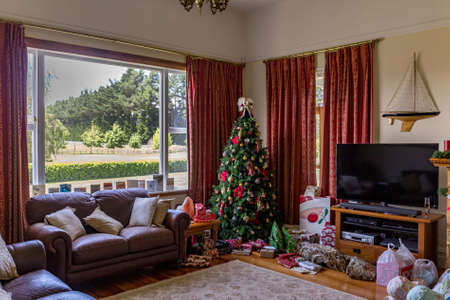 Christmas day at our house with presents under the tree waiting for the kidsの写真素材