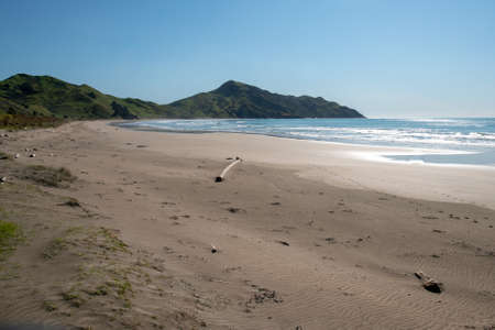 Clean pristine and empty beach leading to the promontoryの写真素材