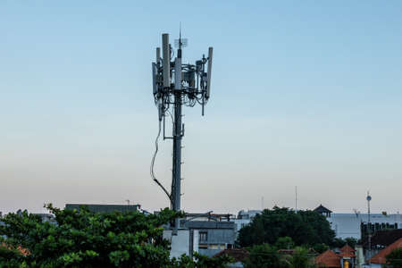 Ugly wires and concrete Telecommunications tower towering above the rooftops of tropical Bali