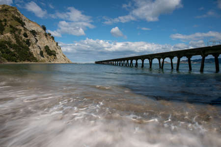 The historic pier at Tokomaru bay vanishing into the distance at New Zealand's east coastの写真素材