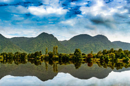 Mirror image reflections of the mountains and the skiesの写真素材