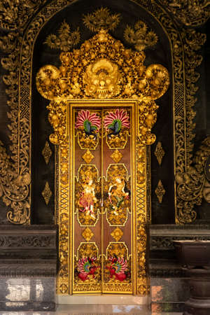 Beautiful golden hindu cultural artwork in the door and doorway inside a traditional Bali dwellingのeditorial素材