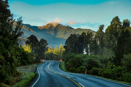 The winding West Coast Road  at the base of the Southern Alps through rain forest terrain between Lake Ianthe and Whataroa Riverの写真素材