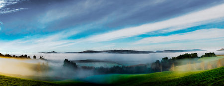Fog and mist covering the rural hills at sunriseの写真素材