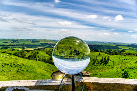 The rural farming agricultural countryside refracted upside down in the Crystal ballの写真素材