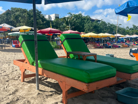 Long chair sun lounger beds for hire on the sand y beach at Legian Baliの写真素材