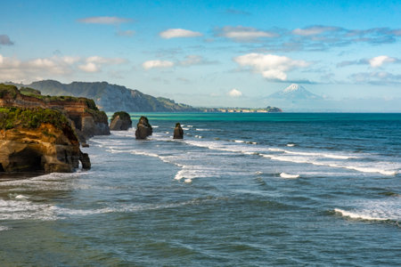 The rock formations known as The three sisters at Tongaporutu beach at high tide on the Taranaki coastlineの写真素材