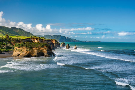 The rock formations known as The three sisters at Tongaporutu beach at high tide on the Taranaki coastlineの写真素材