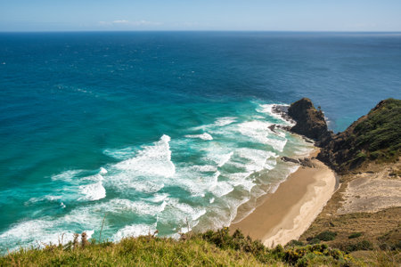 The spot where the Tasman sea and Pacific oceans meet at Cape Reinga and its historic lighthouseの写真素材