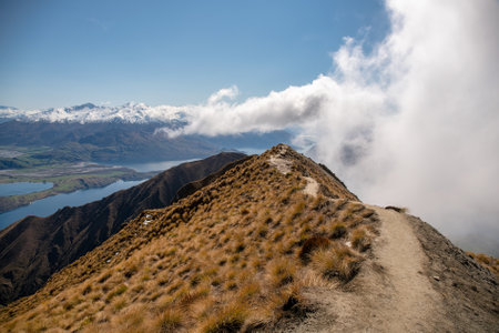 Stunning scenic views of the bays of Lake Wanaka and the snow capped Southern Alps from the Roys Peak mountain trackの写真素材