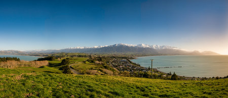 The Kaikoura Peninsula at dawn on the lookout with a glimpse of South Bay on the left, the Main bay on the right and the magnificent mountains to the rearの写真素材