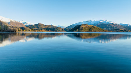 Dawn scenery at Glendhu bay campground  looking across Lake Wanaka towards the snow capped mountains in Mt Aspiring National Parkの写真素材
