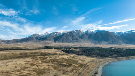 The untouched beauty of Lake Ohau surrounded by the snow capped southern alps mountain rangeの写真素材
